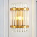 Modern golden crystal shade wall sconce with clear crystal rods and fluted glass accents for bedroom wall lamp