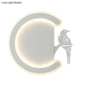 Modern gray wall lamp with a sleek curved frame and warm white light featuring a stylized bird silhouette