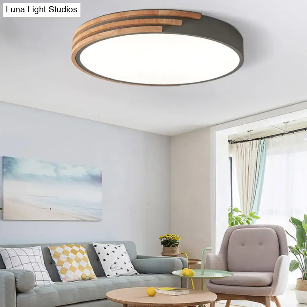Modern round flush mount ceiling light by DecorBites with dark metal frame and concentric wooden slats in grey white green