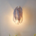 Modern grey and white furry goose feather wall lamp with soft pale gray ostrich feather texture and golden hooks