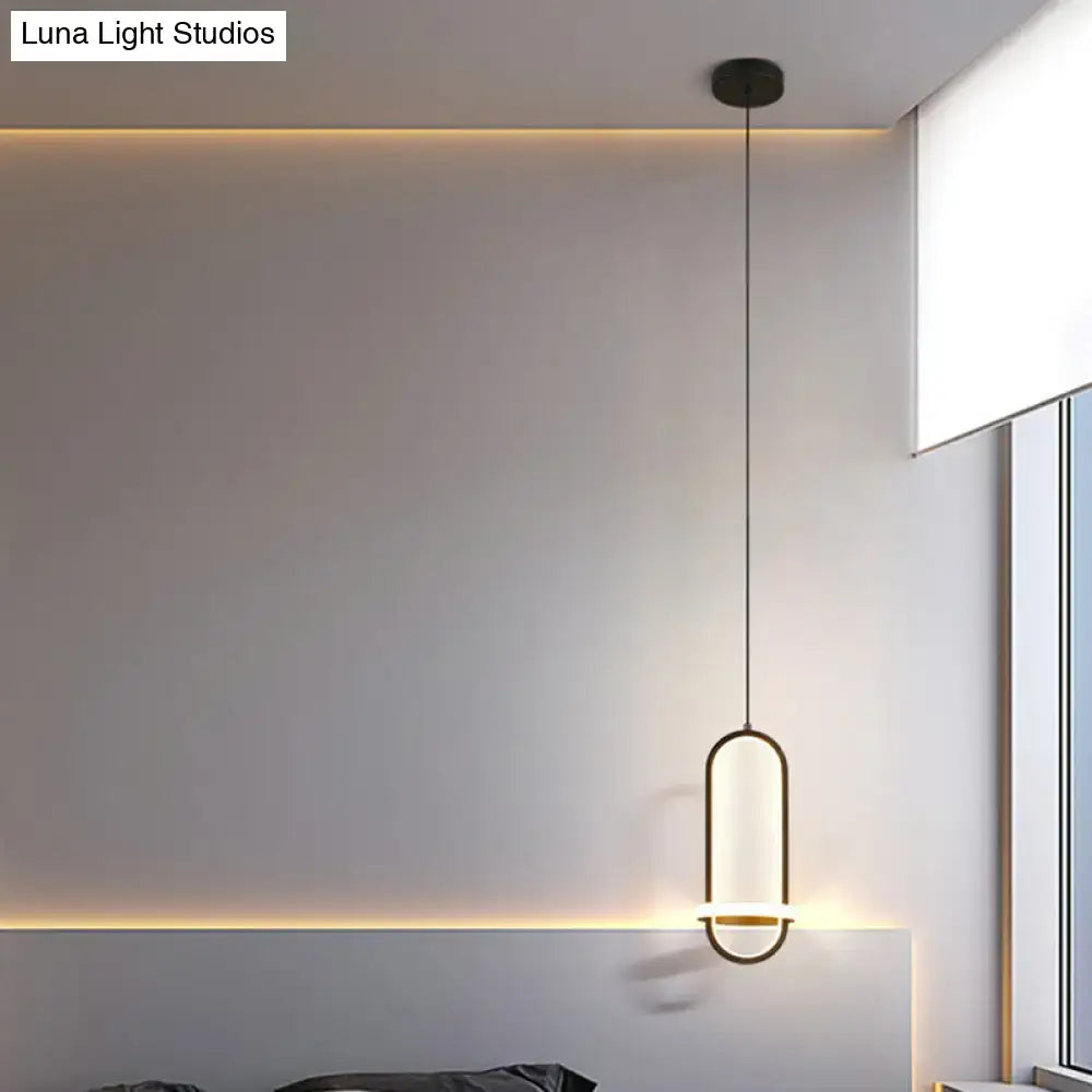 Modern halo ring bedside pendant light with sleek black metal frame and warm glowing led illumination for bedroom