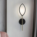 Modern leaf-shaped wall light with black frame and gold finish brass stem for living room use