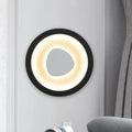 Modern minimalist black wall light with acrylic shade featuring a glowing warm white ring and irregular mirror for bedroom