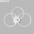 Modern minimalist white wall sconce light fixture with three interlocking rings for bedroom lighting