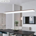 Modern minimalist pendant light fixture with white aluminum body and wood-toned top edge for dining room use