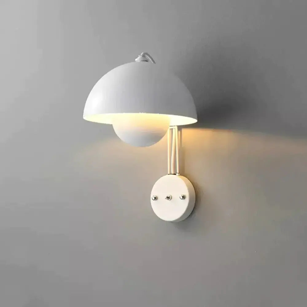 White matte-finished wall lamp with brass base type and dome-shaped shade in a modern mushroom design for bedrooms