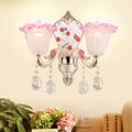 Modern pink and white ruffle glass sconce lamp with crystal droplets and ornate silver metalwork for bedroom wall light