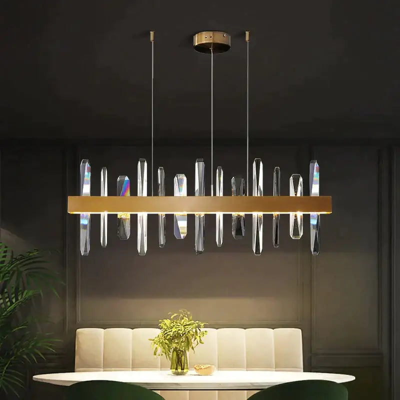 Modern rectangle gold crystal chandelier by decorbites featuring a gold-toned frame with hanging crystal prisms