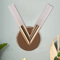 Modern v-shaped bedroom sconce with rose gold metallic finish and white glass shade for elegant lighting