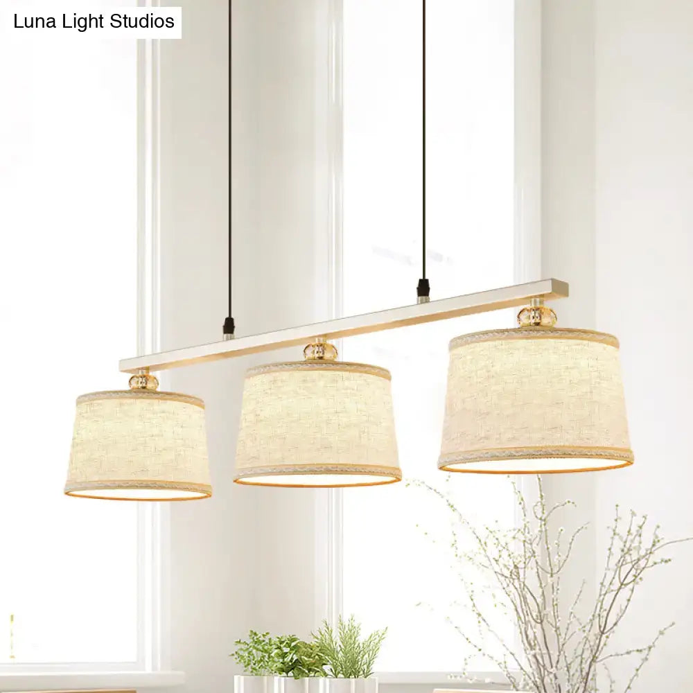 Modern silver and flaxen circle pendant light for kitchen island