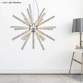 Silver starburst chandelier pendant with clear crystal rods radiating from a central chrome fixture for hanging ceiling use