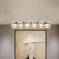 Modern silver crystal tube island light with a sleek metal frame and multiple embedded lights for dining rooms
