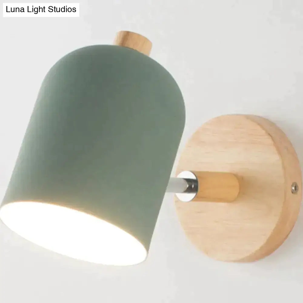 Modern teal and wood wall lamp with a matte sage green ceramic shade and natural wood base for bedroom sconce use