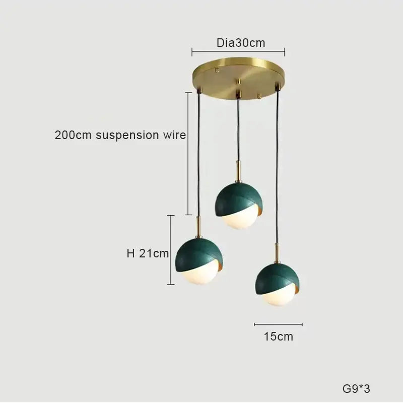 Modern teal glass and brass pendant light for kitchen island