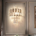 Modern tiered smoke gray crystal wall sconce with clear and smoky glass rods on a sleek metallic frame for living room