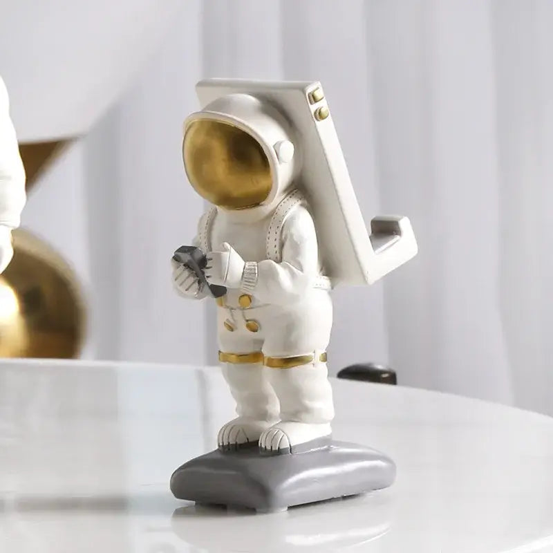 Modern white and gold astronaut phone holder living room figurine
