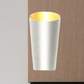 A modern led bedside sconce wall light with a sleek white cylindrical body and warm gold interior lining