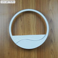 Modern white acrylic wall sconce with circular minimalist design and warm white light for bedroom use