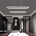 Three sleek modern white elliptical island led ceiling lights with minimalist acrylic design for table lighting