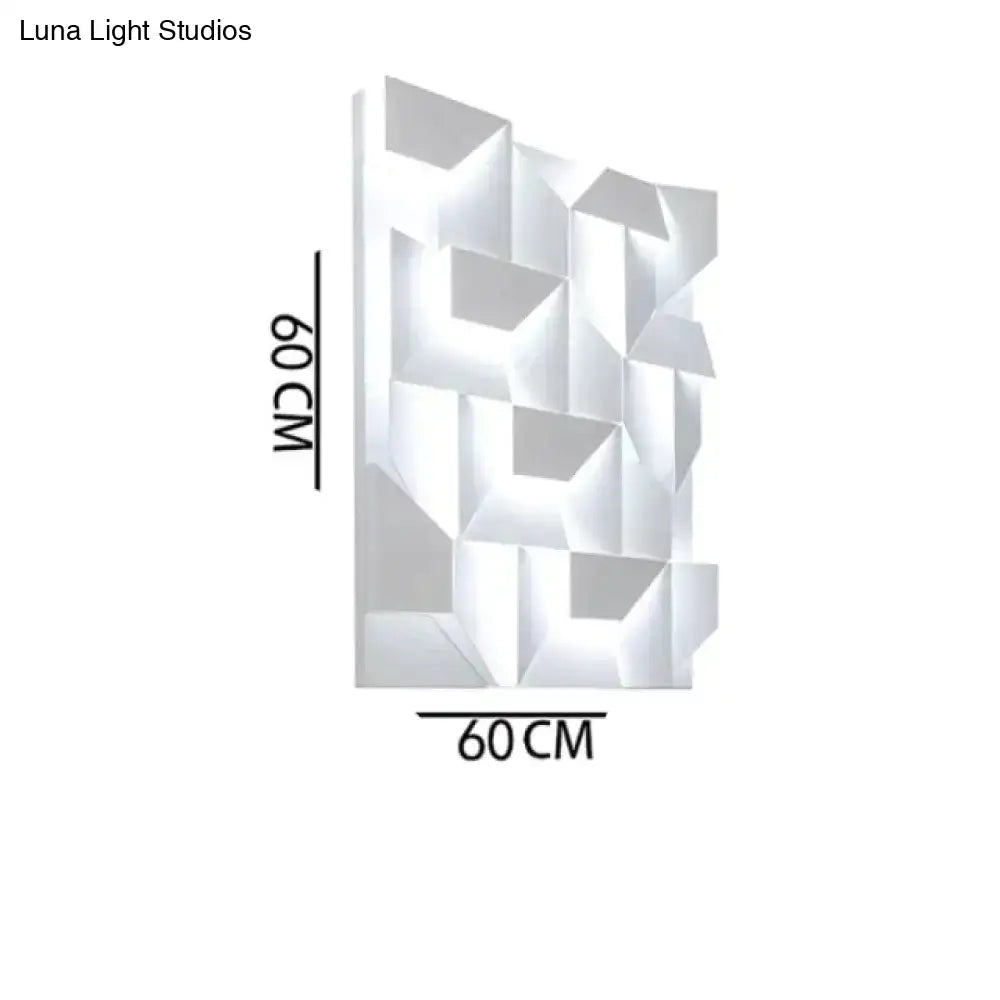 Modern white geometric wall lamp with faceted design illuminated as living room art panel