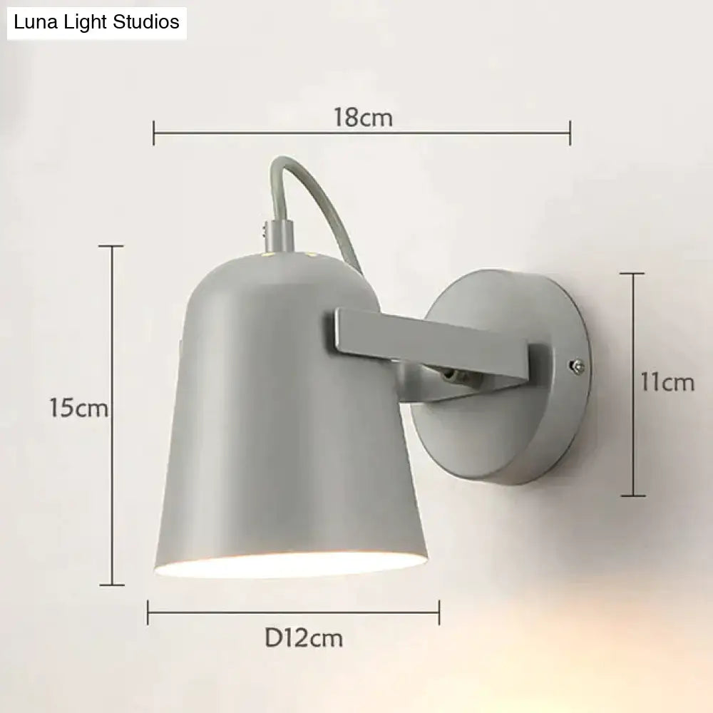 Gray matte-finished ferrell wall lamp with sleek modern design and adjustable arm for bedroom spotlight use