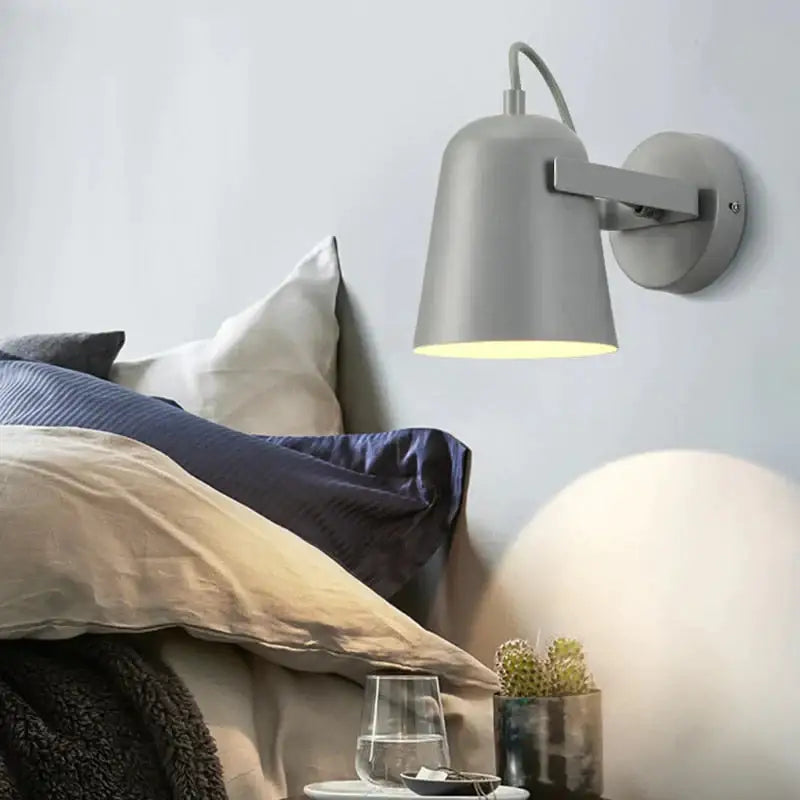 Modern gray metal ferrell wall lamp with sleek minimalist design and adjustable spotlight for bedroom lighting