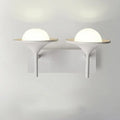Modern white metallic flared wall sconce with frosted glass dome and sleek base for bedroom LED lighting