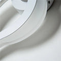 Modern white spiral led wall sconce featuring smooth curved layers in an 8 inch fixture suitable for corridor lighting
