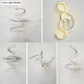 Modern white led wall sconce with a sleek spiraling design shaped as an illuminated treble clef for bedroom lighting