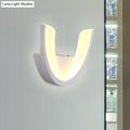 Modern white u-shaped led wall sconce with sleek curved design and warm white light for bedroom illumination