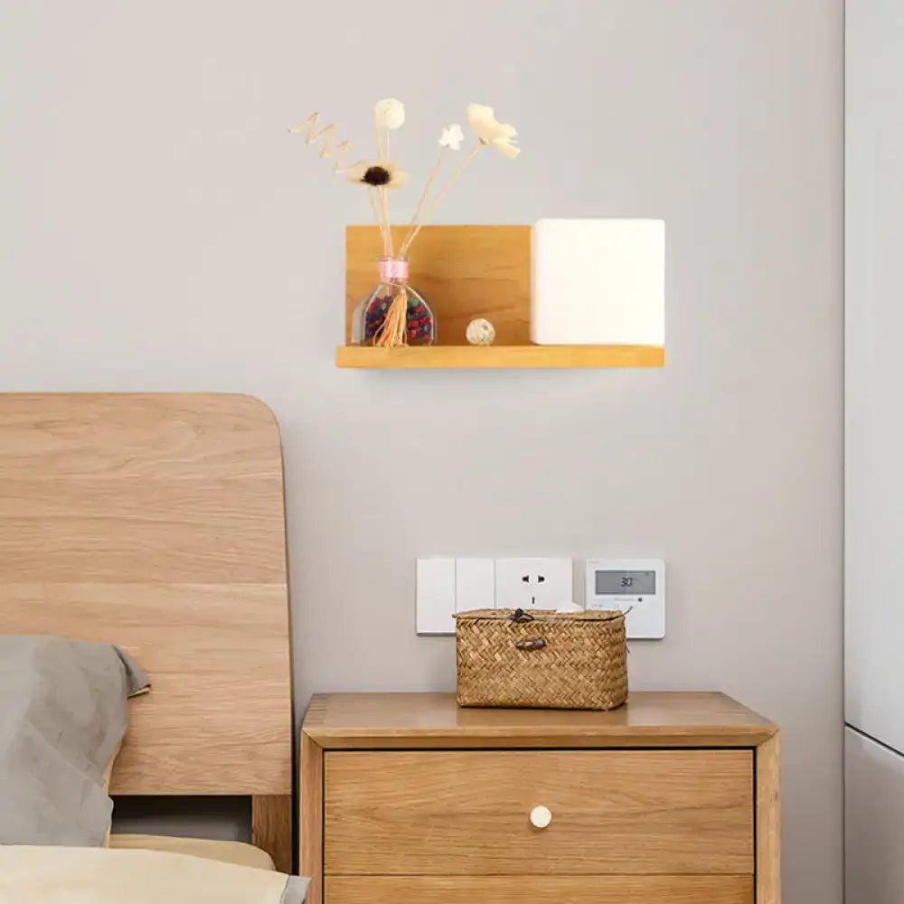 Lightweight wooden floating shelf with natural grain and warm beige finish paired with a bedroom sconce light