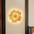 Modern wood flower wall light sconce in warm tones with a central brass accent for bedroom lighting
