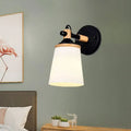 Modernist wall lamp with black and wood finish and cream glass shade ideal for bedroom lighting