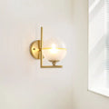 Modernist brass direct wired electric wall sconce with frosted glass globe and yellow accent band for bedroom light fixture
