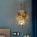 Modernist brass finish wall sconce with gold-toned crystal shade lotus flower design and central illuminated bloom