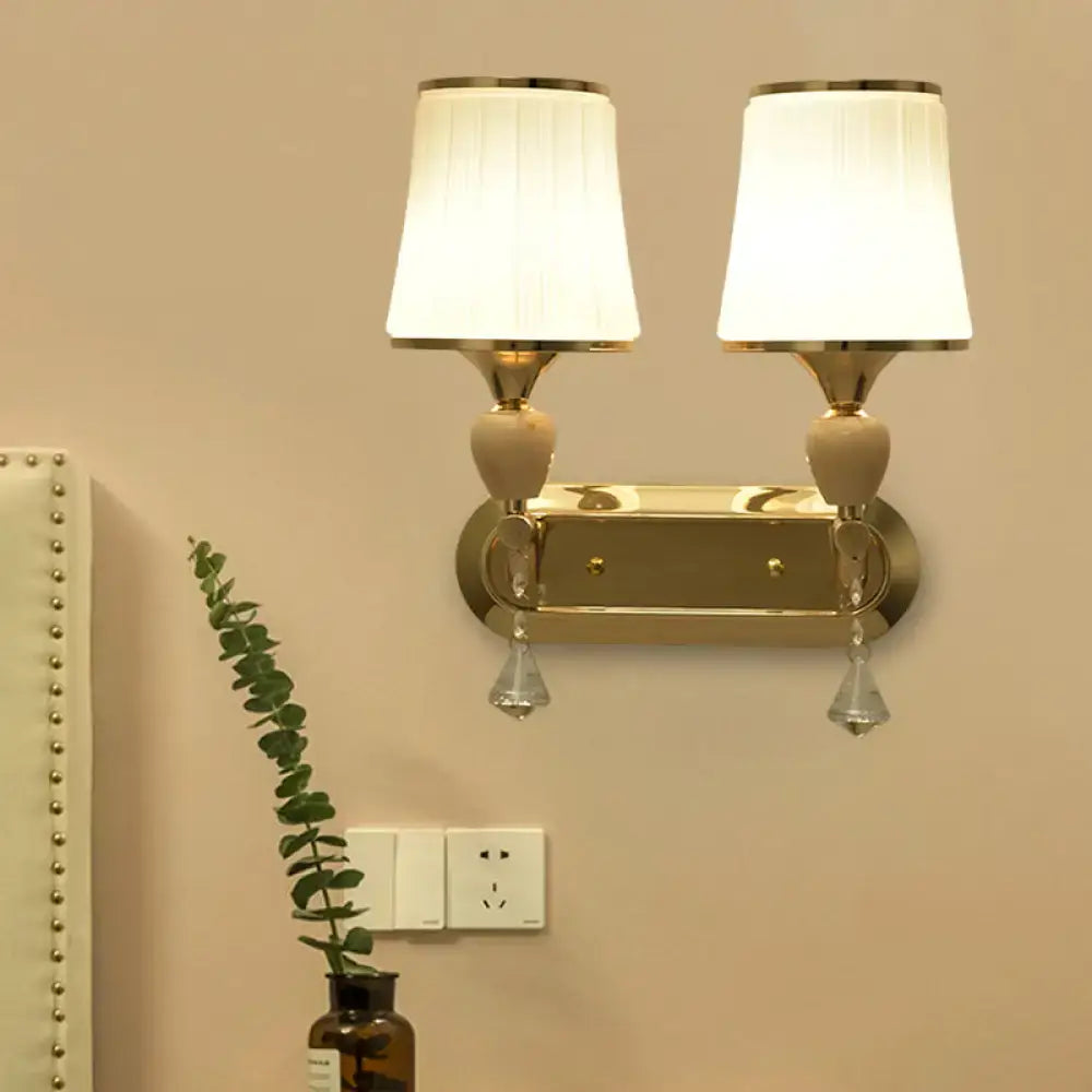 Modernist gold crystal wall sconce with pleated shades living room