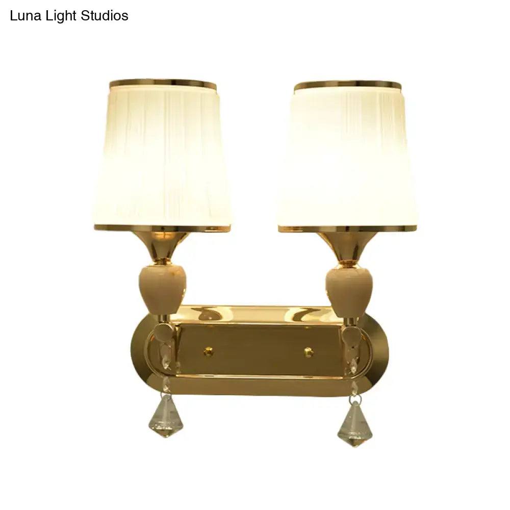 Modernist gold crystal wall sconce with pleated shades living room