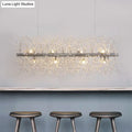 Decorbites modernist metallic branch island pendant light in silver with crystal bead deco strands emitting warm light
