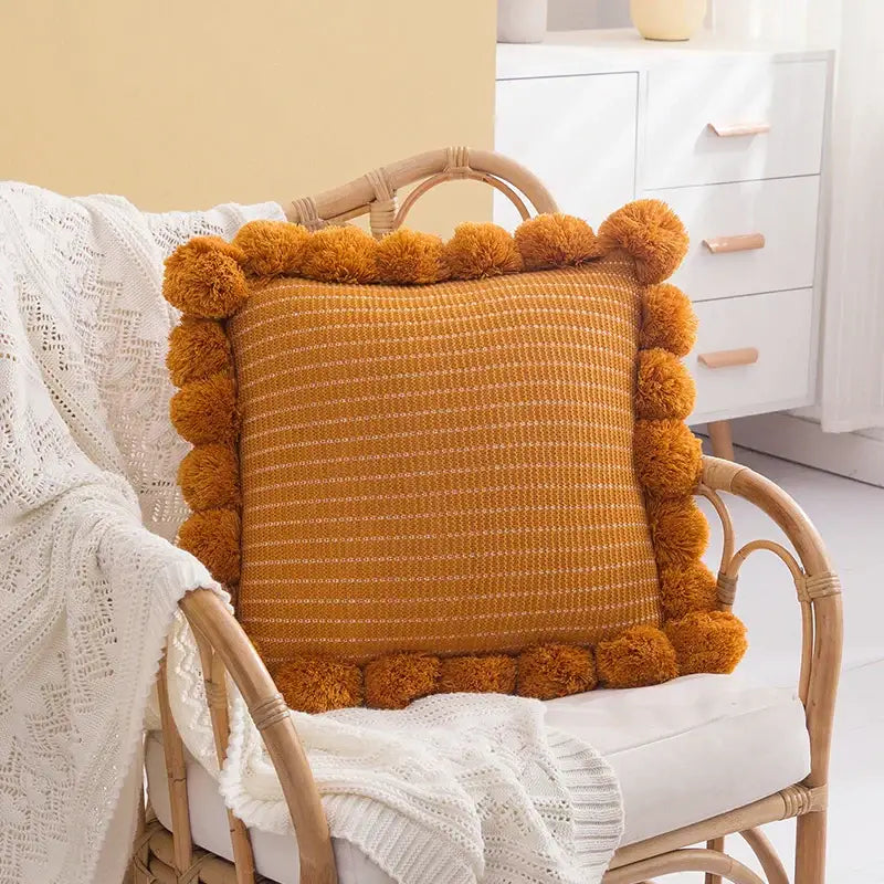 Orange textured ball cushion cover with pompoms living room decor