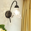 Post-modern black metal wall sconce with clear crystal shade bedroom