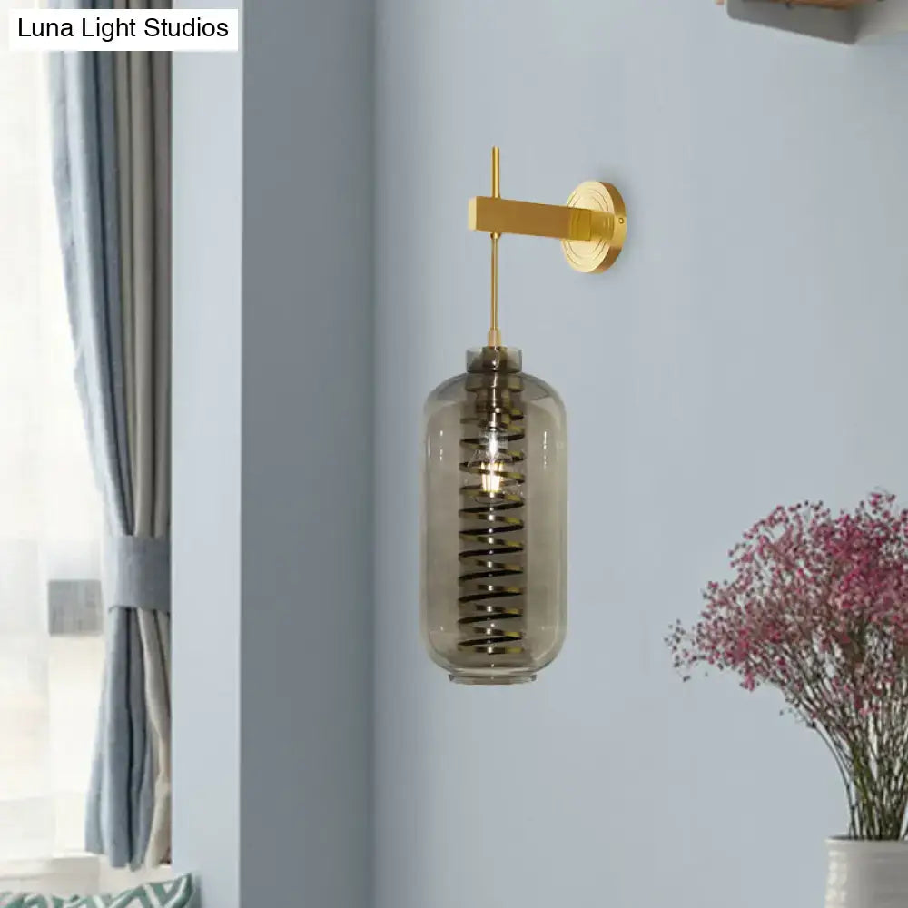 Post-modern brass and smoke gray glass cylinder sconce – bedroom light