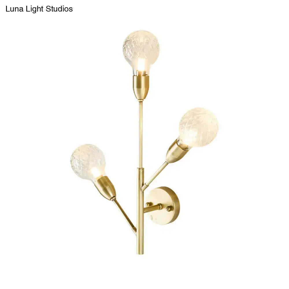 Post-modern brass wall light fixture with clear lattice glass bedroom