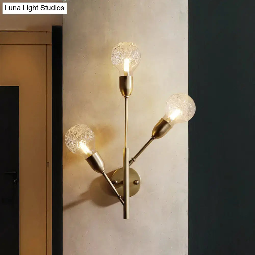 Post-modern brass wall light fixture with clear lattice glass bedroom