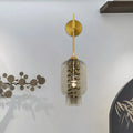 Postmodern brass wall lamp with smoke gray glass shade and gold metal stem for tea room lighting