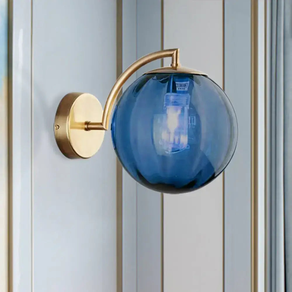 Postmodern brass armed ball sconce – bedroom amber glass wall light