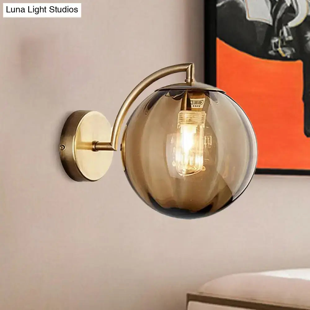 Postmodern brass armed ball sconce – bedroom amber glass wall light