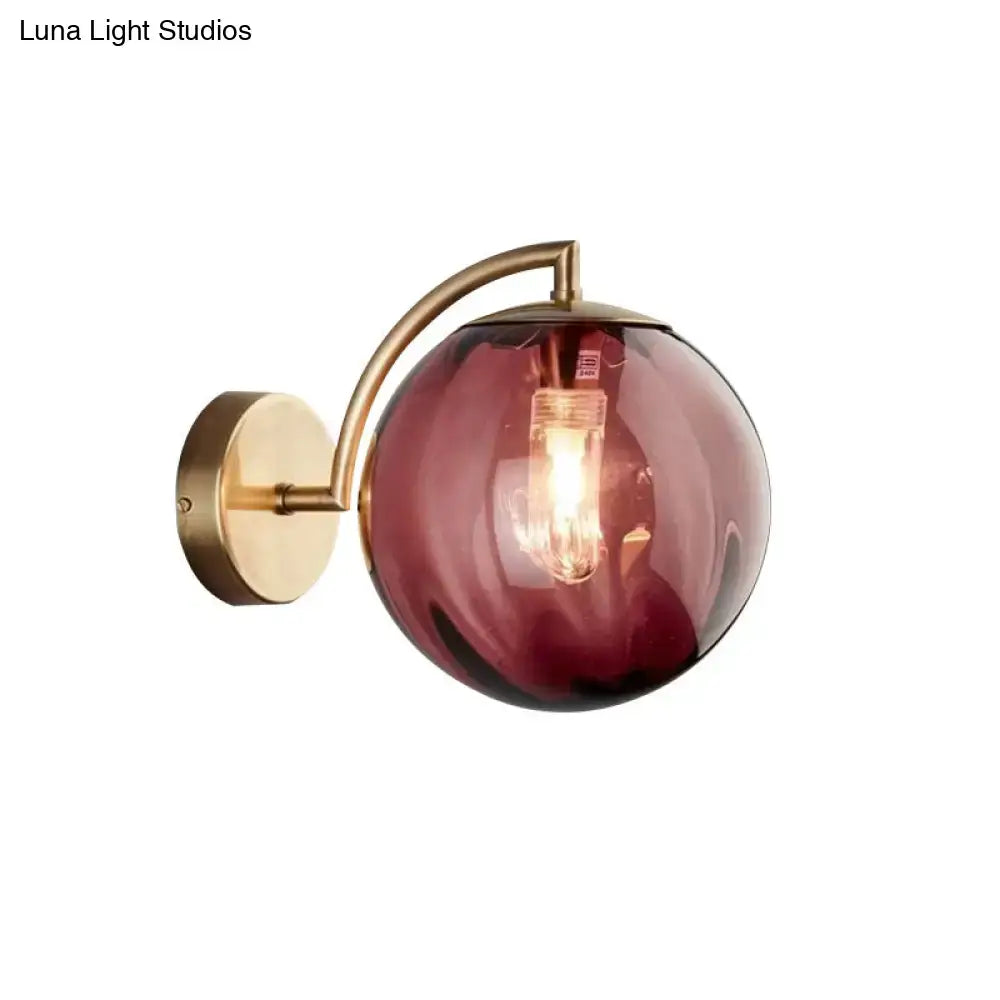 Postmodern brass armed ball sconce – bedroom amber glass wall light