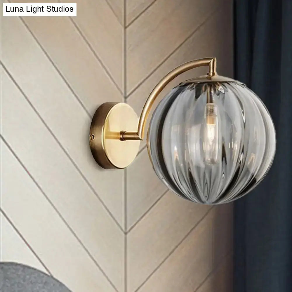 Postmodern brass armed ball sconce – bedroom amber glass wall light