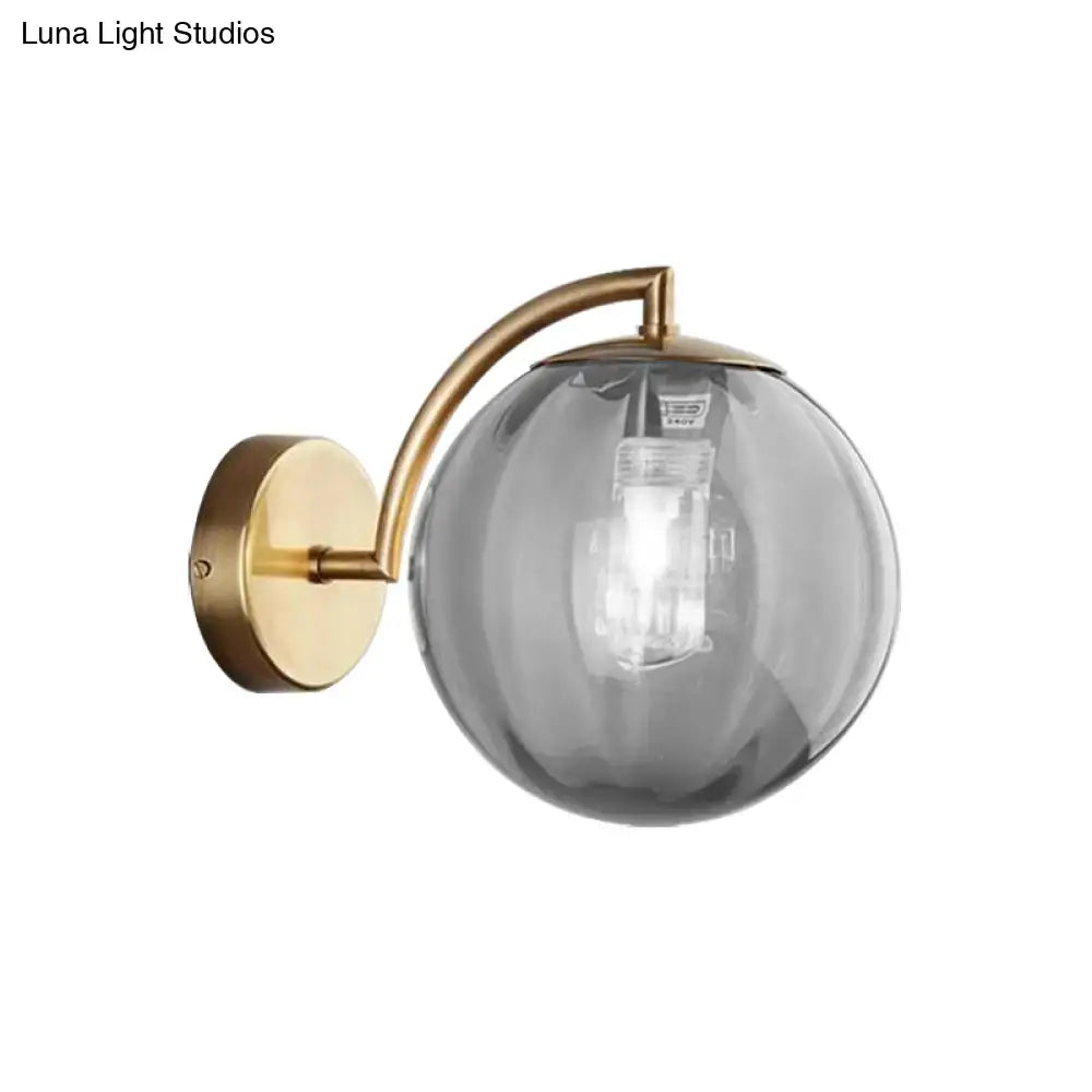 Postmodern brass armed ball sconce – bedroom amber glass wall light