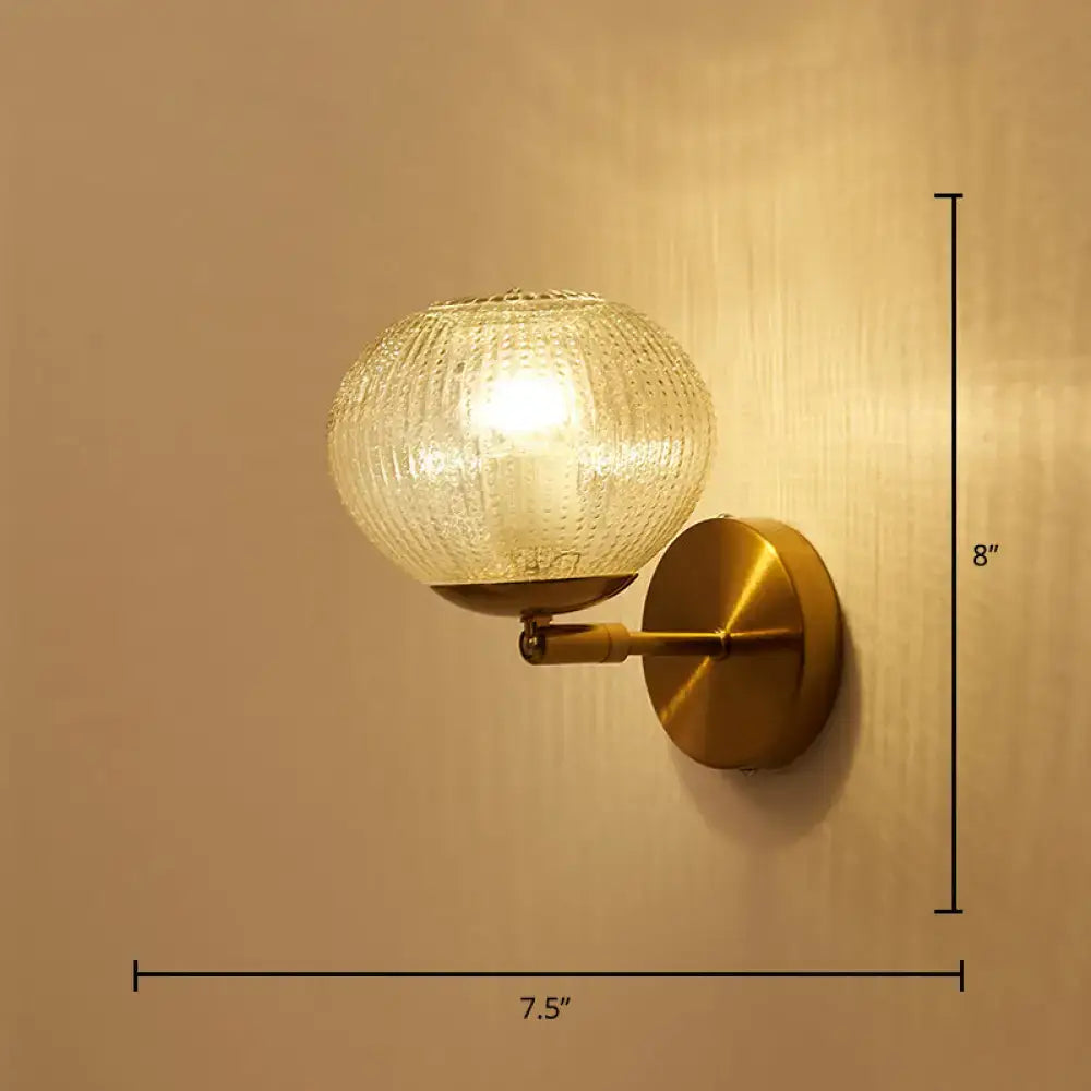 Postmodern gold ball shaped wall sconce with textured glass shade bedroom light